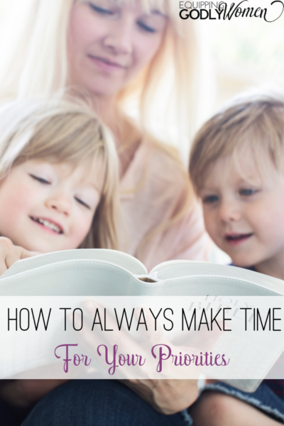 Mom making time for priorities reading to two children.