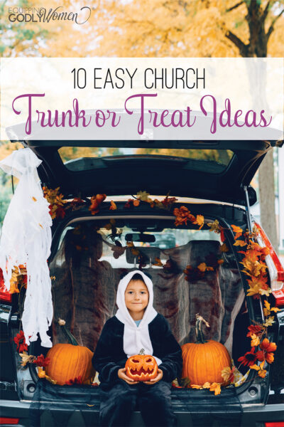 Two children sitting in a trunk decorated with church trunk or treat ideas for Halloween