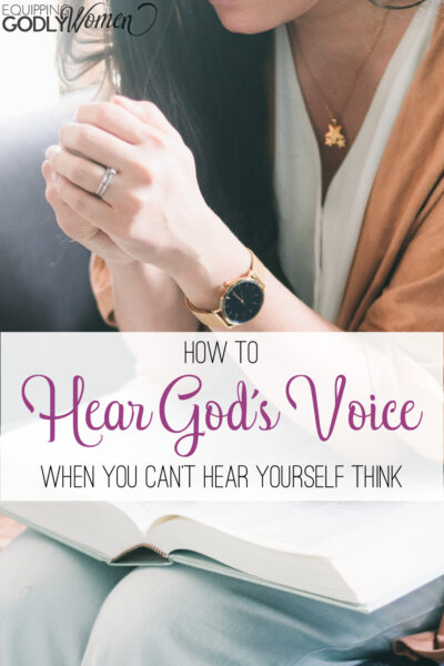 This woman has her bible open in prayer and learning how to hear God's voice.