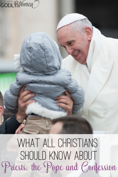 The Pope smiling next to a small child being held by an adult