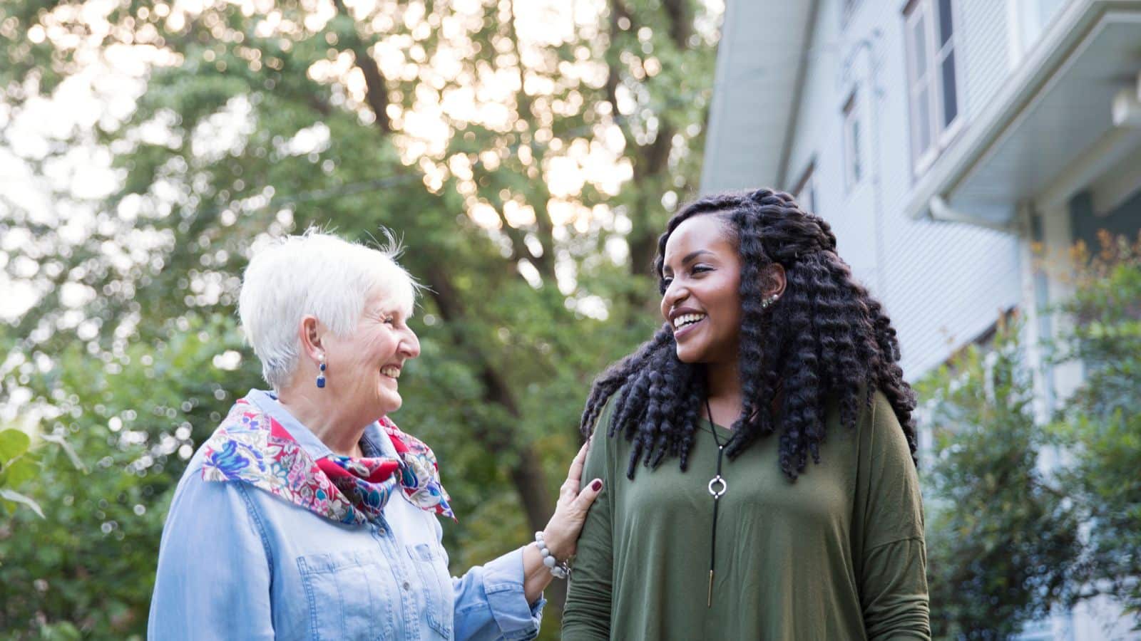 Older woman and younger woman smiling at each other