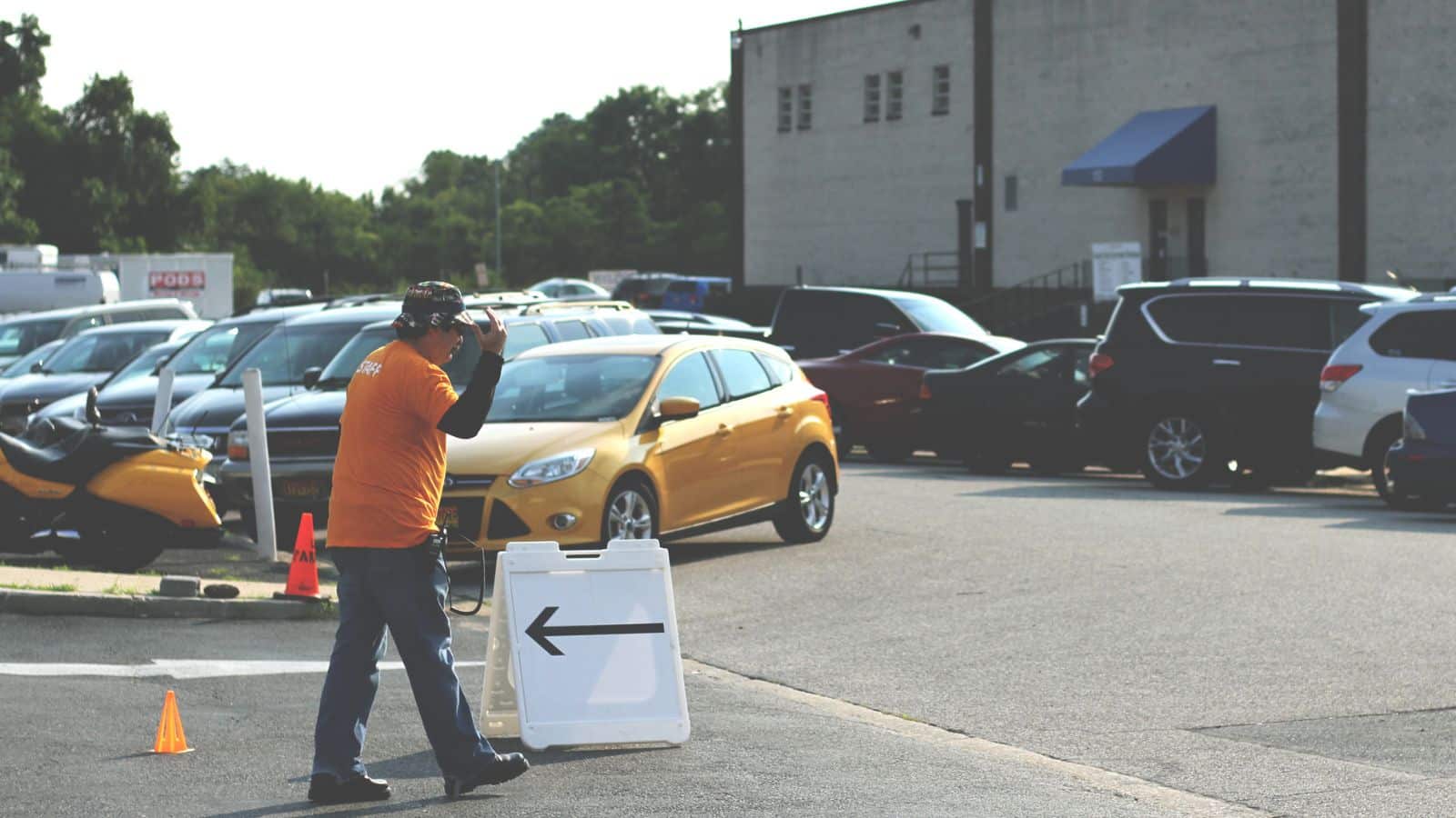 Volunteer directing traffic in parking lot