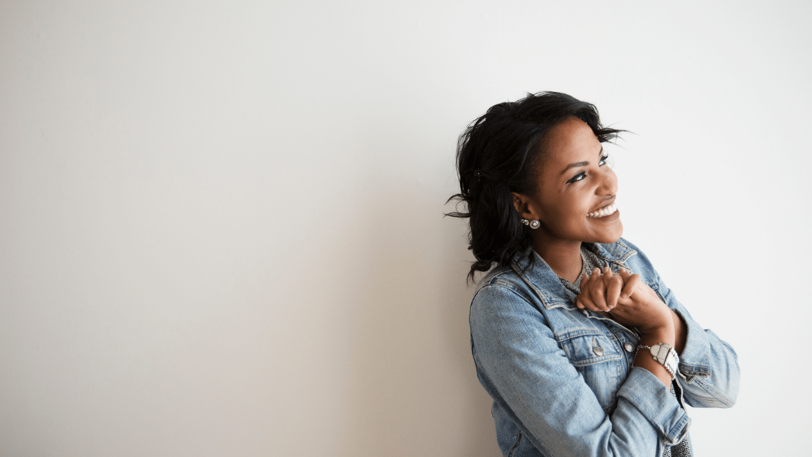 African American woman smiling with her hands folded