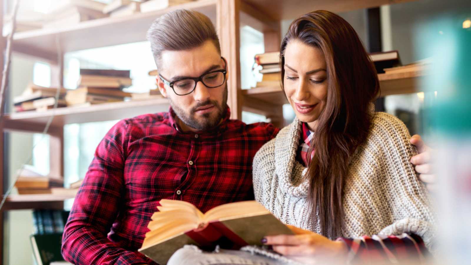 Couple at library reading book