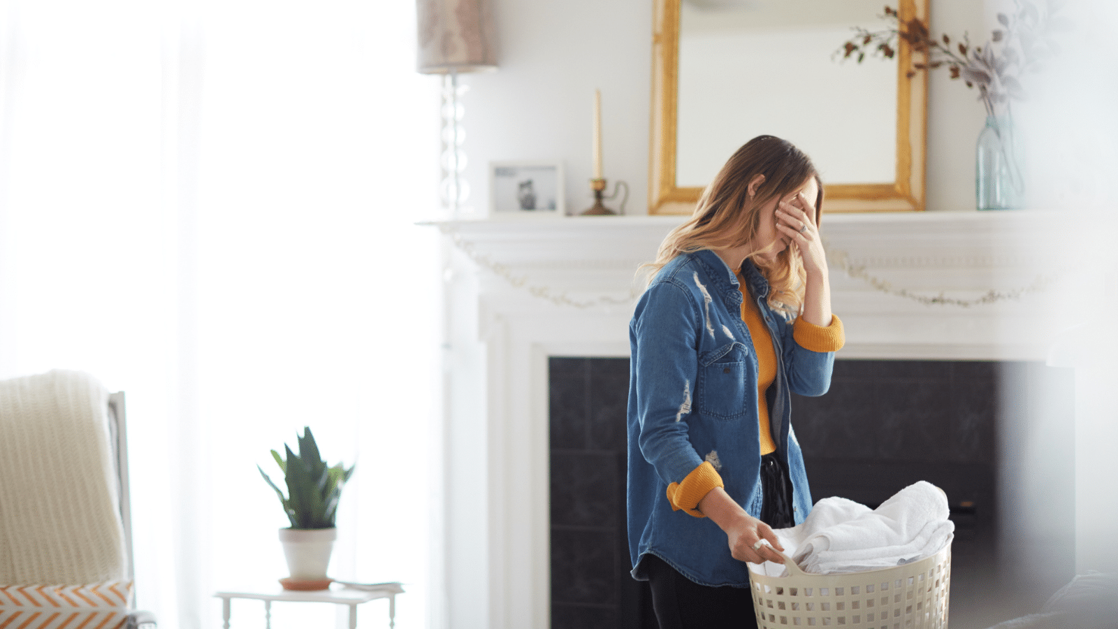 woman folding laundry exhausted
