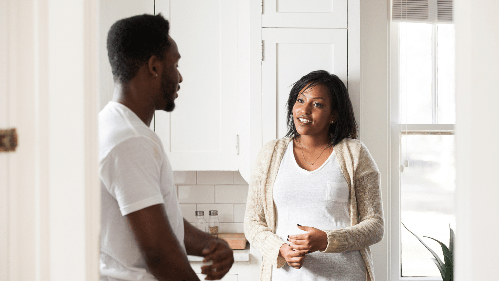 couple talking in kitchen