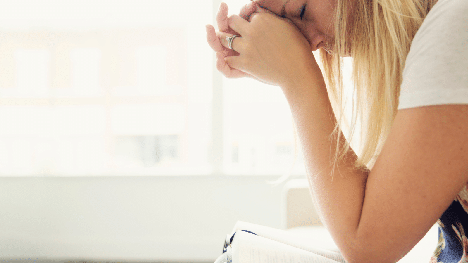 Woman Praying over Bible