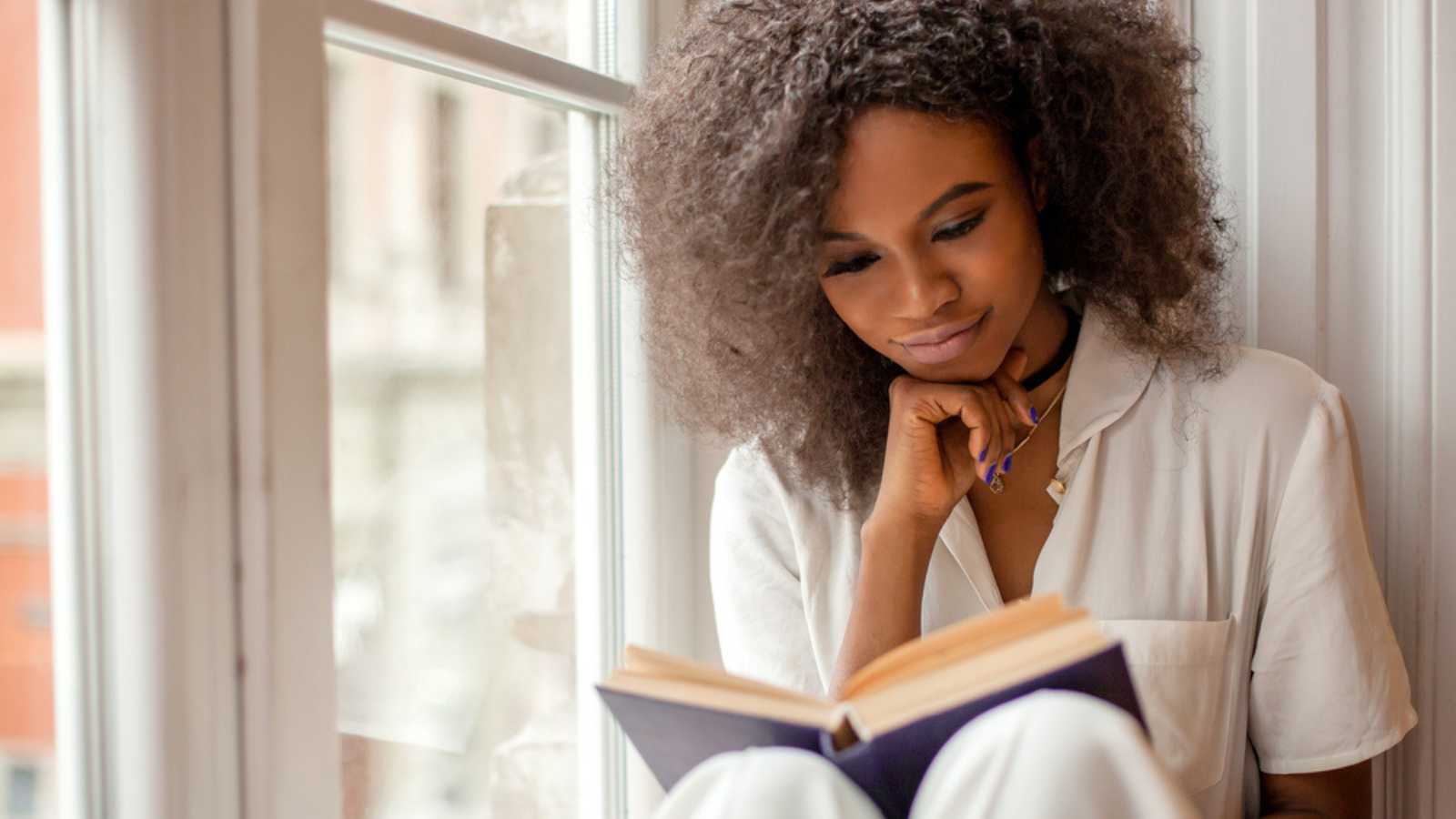 Woman sitting alone and reading book