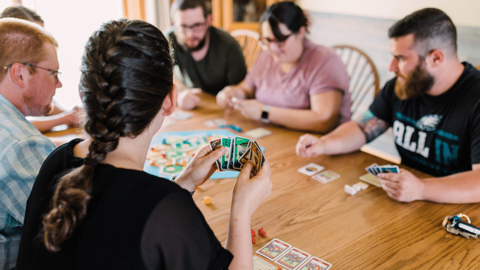 adults playing board games around a table