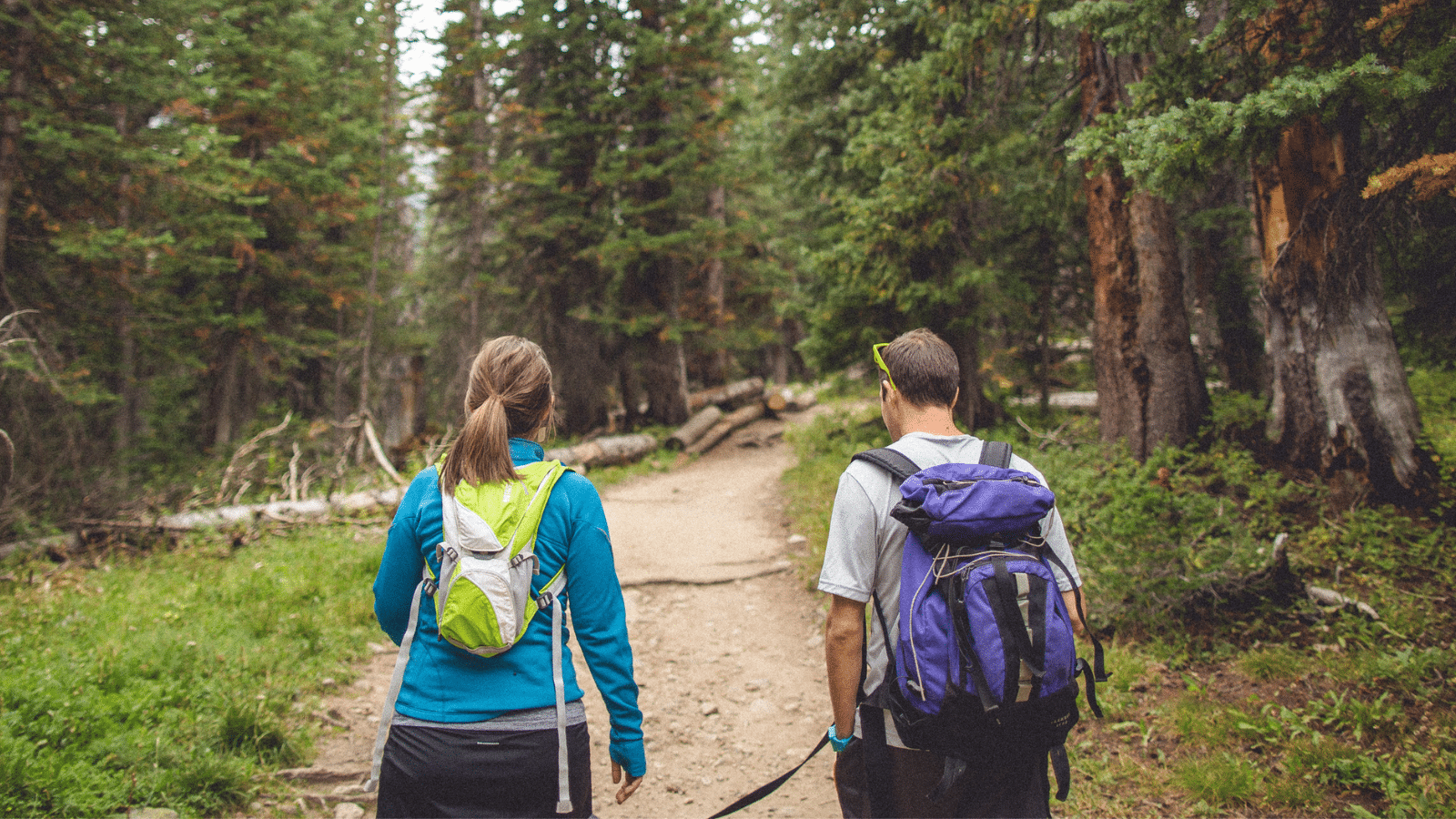 couple hiking to campsite