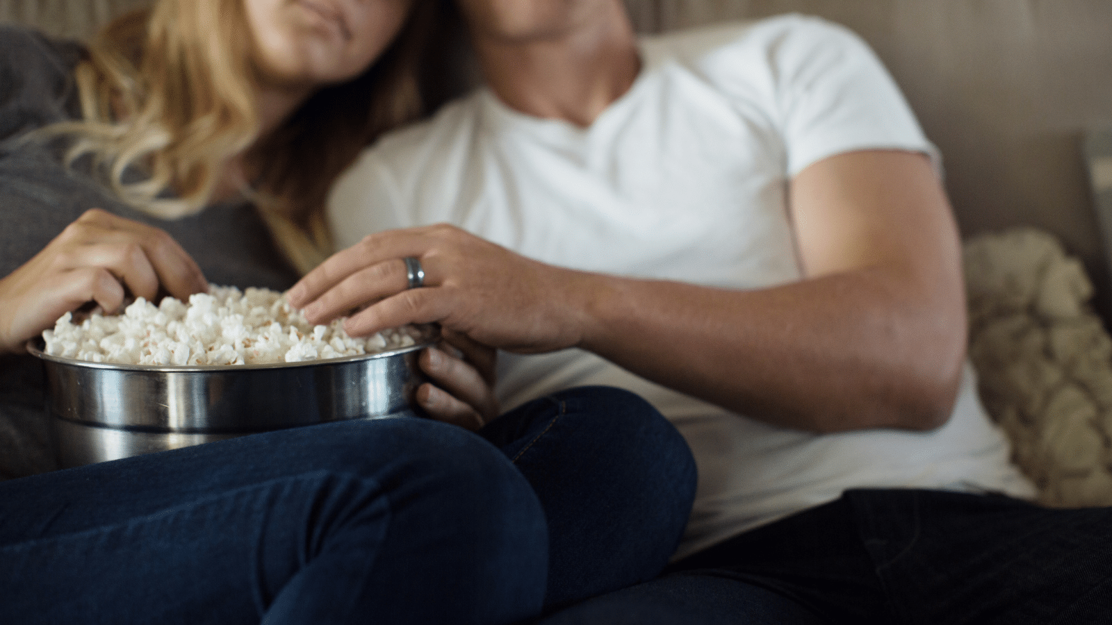 couple watching movie with popcorn