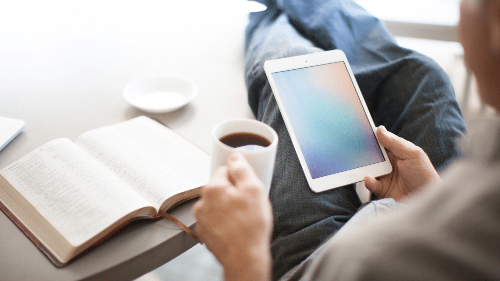 man reading phone distracted from Bible