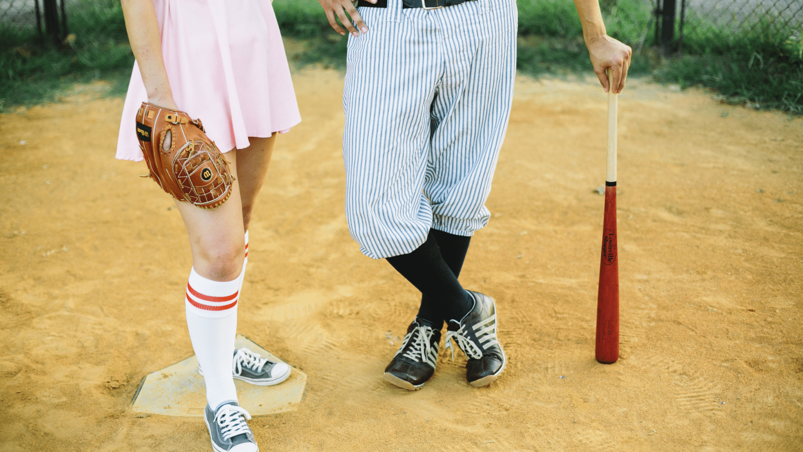 man and woman dressed for baseball