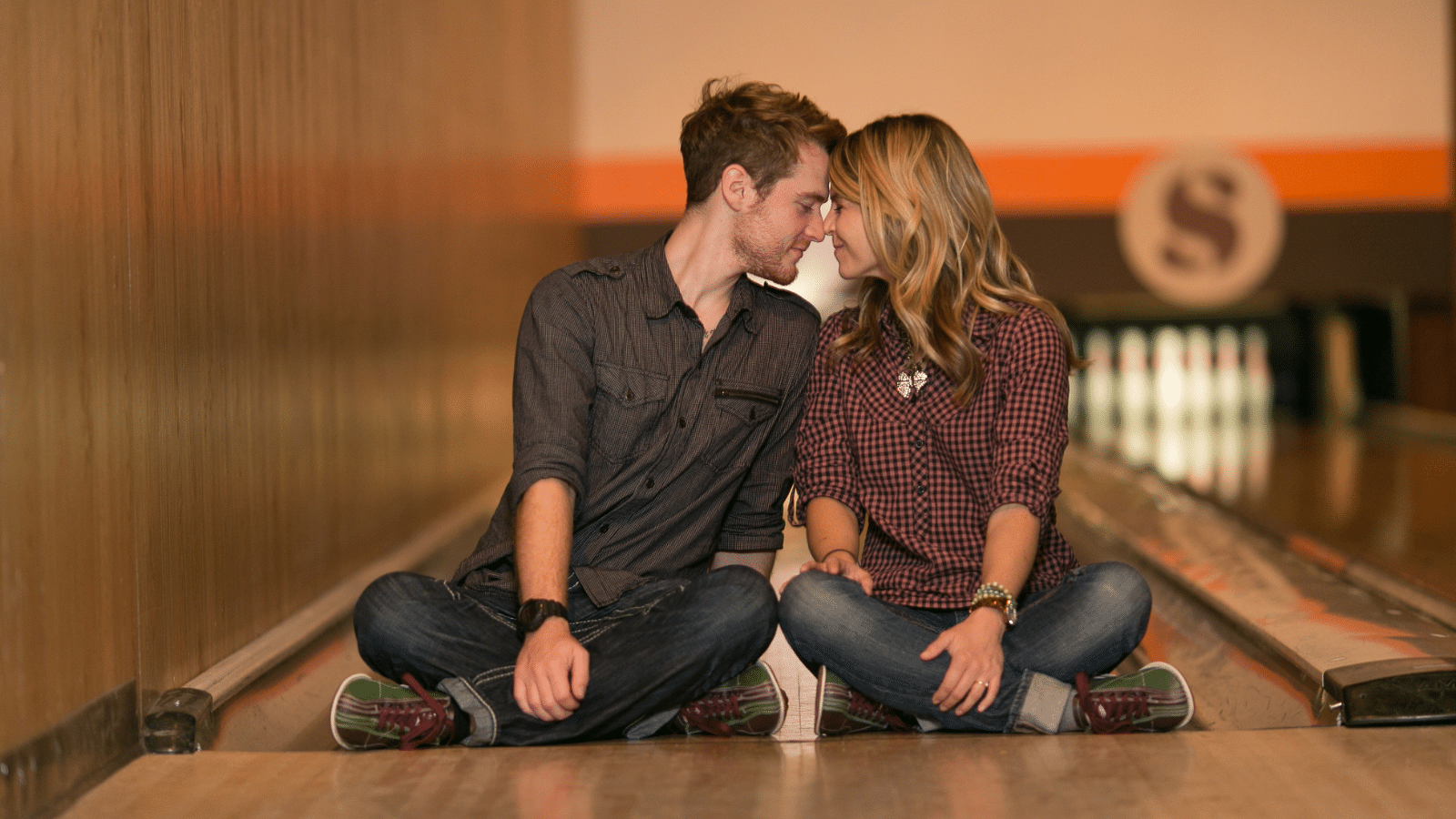 married couple sitting at a bowling alley