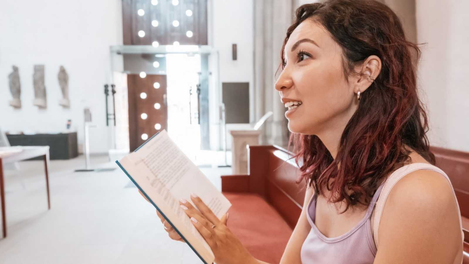 woman singing and reading at church