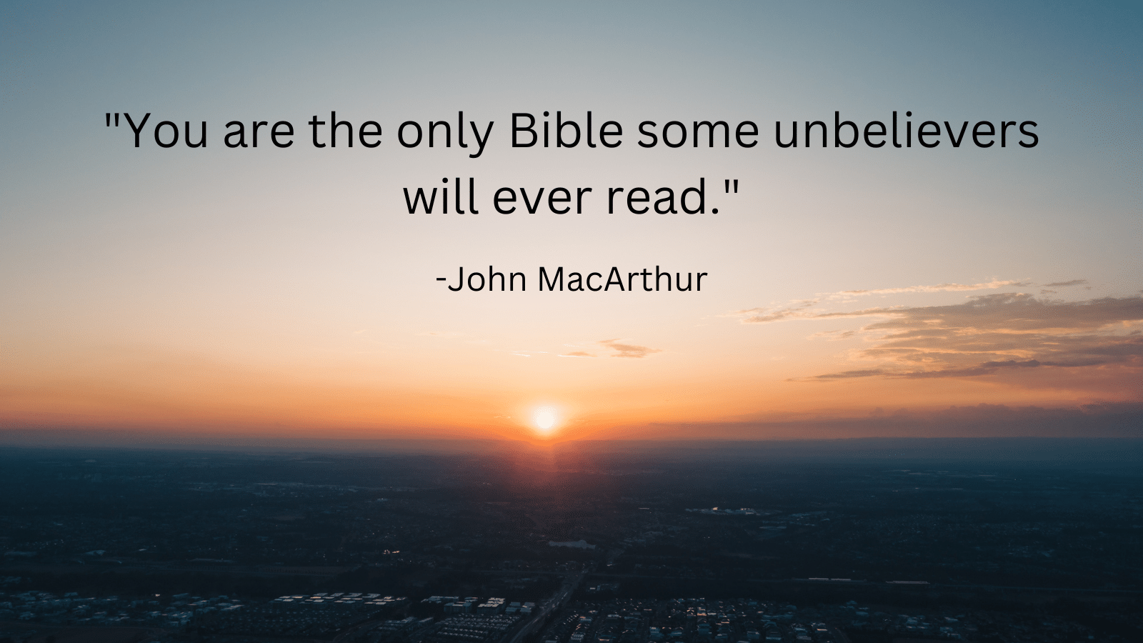 City at sunset with John MacArthur quote