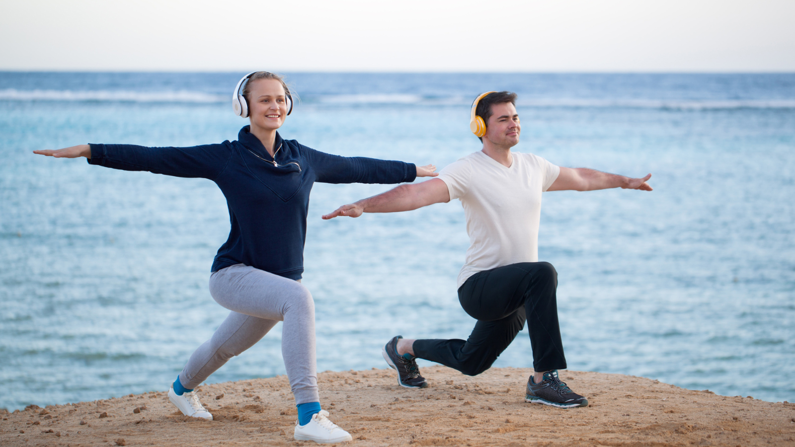 couple doing yoga and listening to music