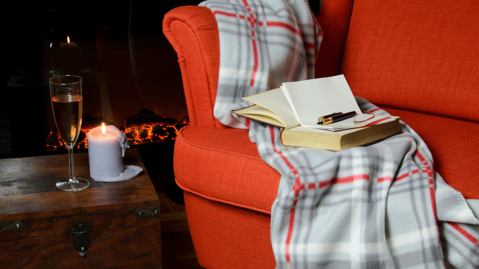 book on a couch with fire in background