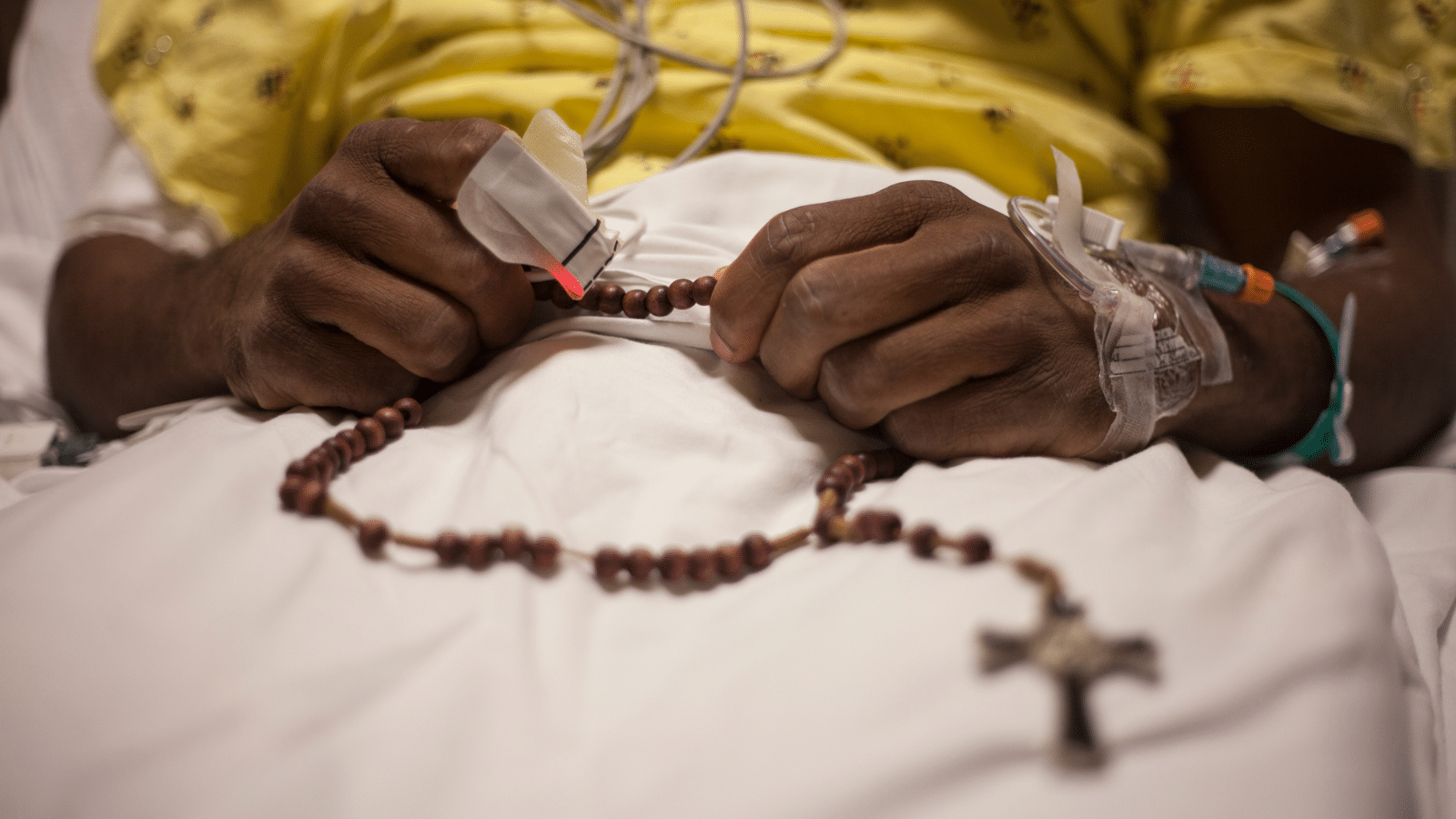 hospital patient with rosary beads