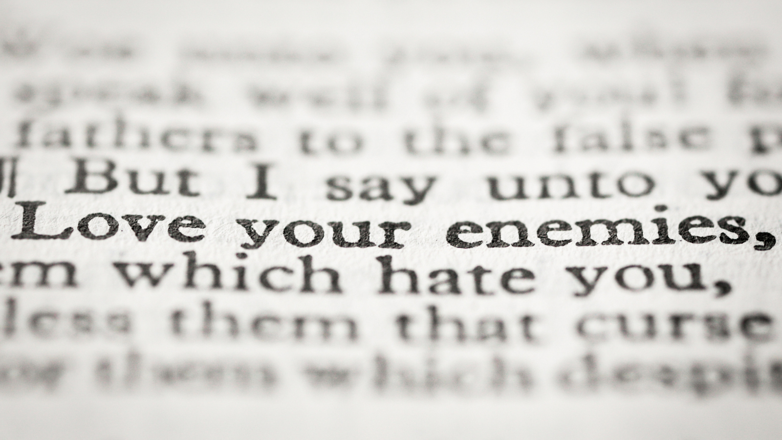 Zoomed in on a Bible showing "I say love your enemies, which hate you."