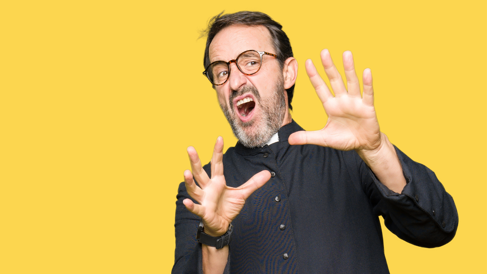 A pastor with his hands up, looking like he doesn't agree with what someone is doing, with a yellow background.