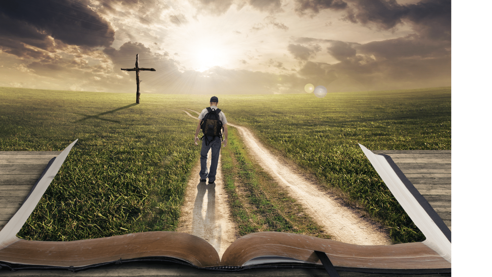 Man walking a path on a bible towards a cross at sunset.
