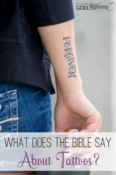 woman with forgiven tattoo holding Bible with words What Does the Bible Say About Tattoos