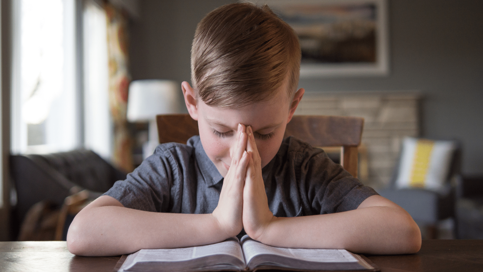 boy child reading the Bible and praying