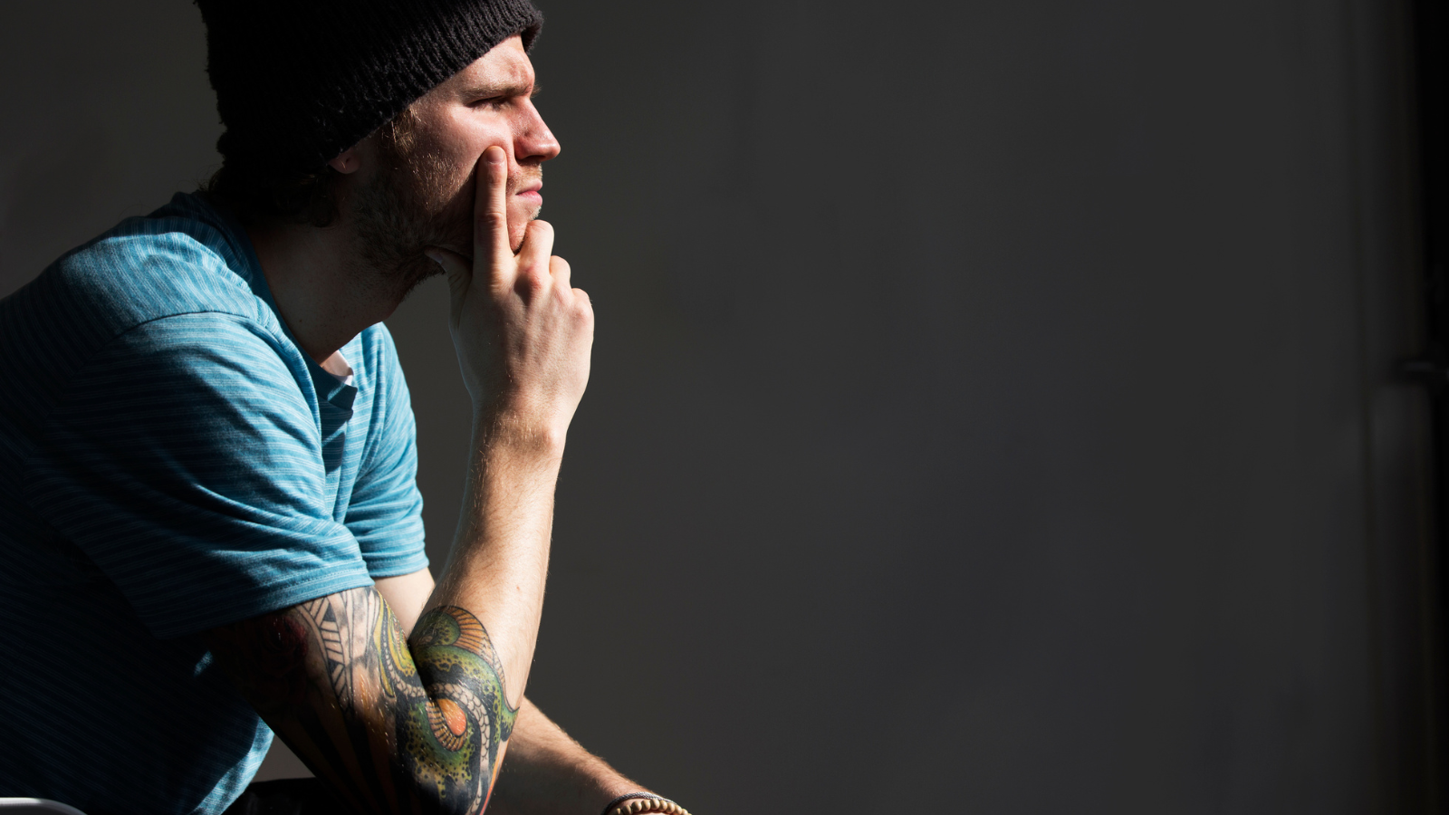 man in beanie hat with tattoo