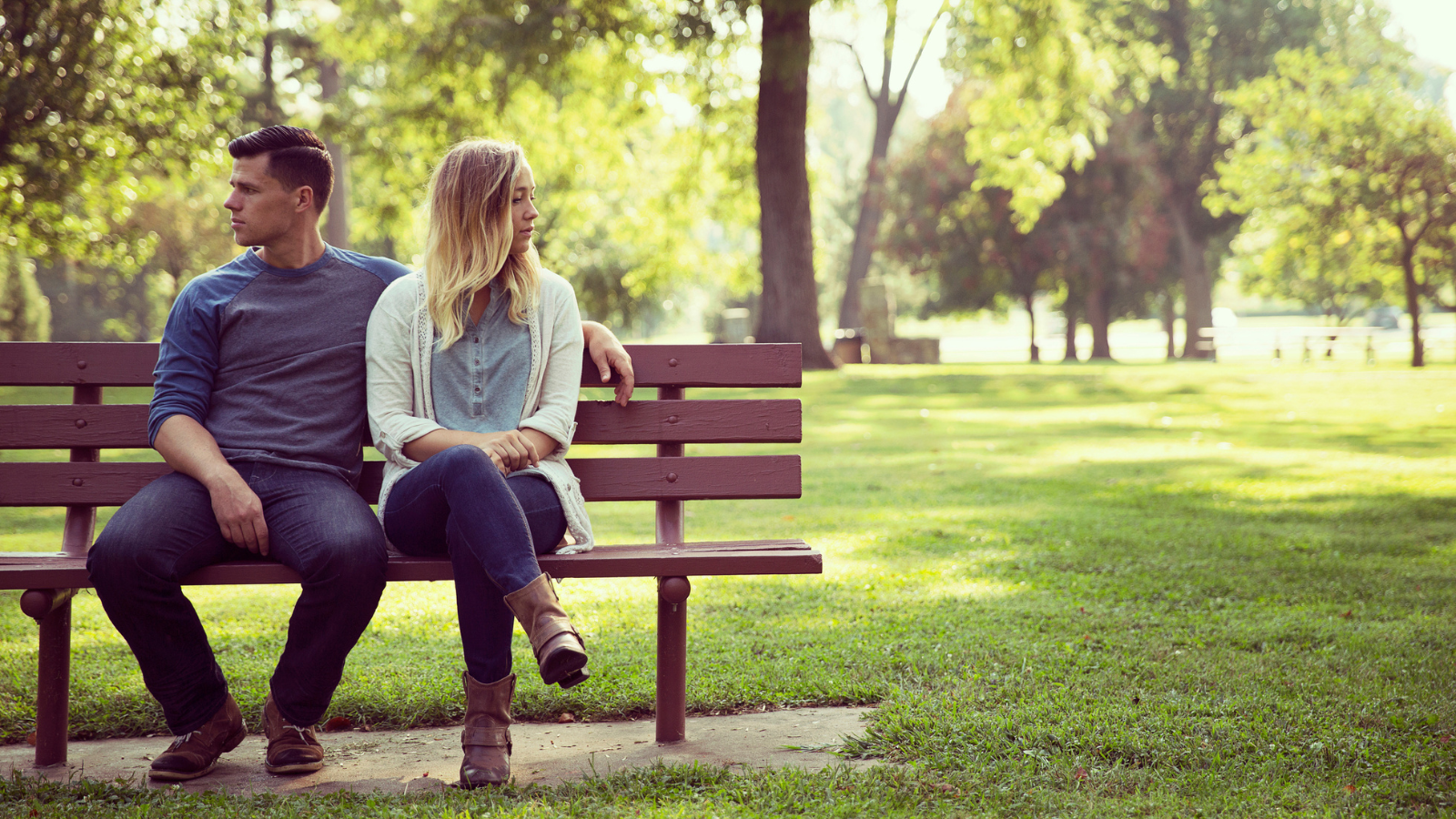 married couple on bench looking away