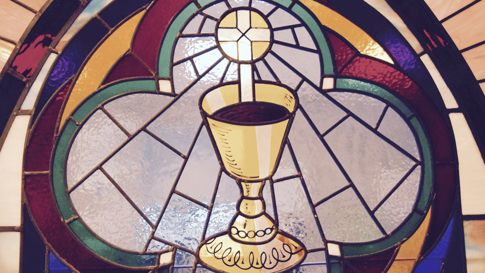 stained glass window with chalice and cross