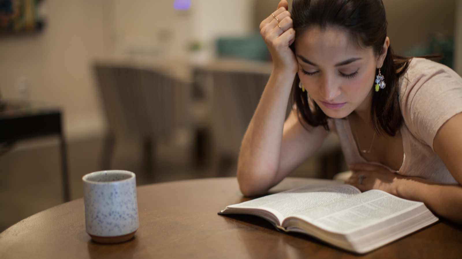 tired woman with Bible and coffee