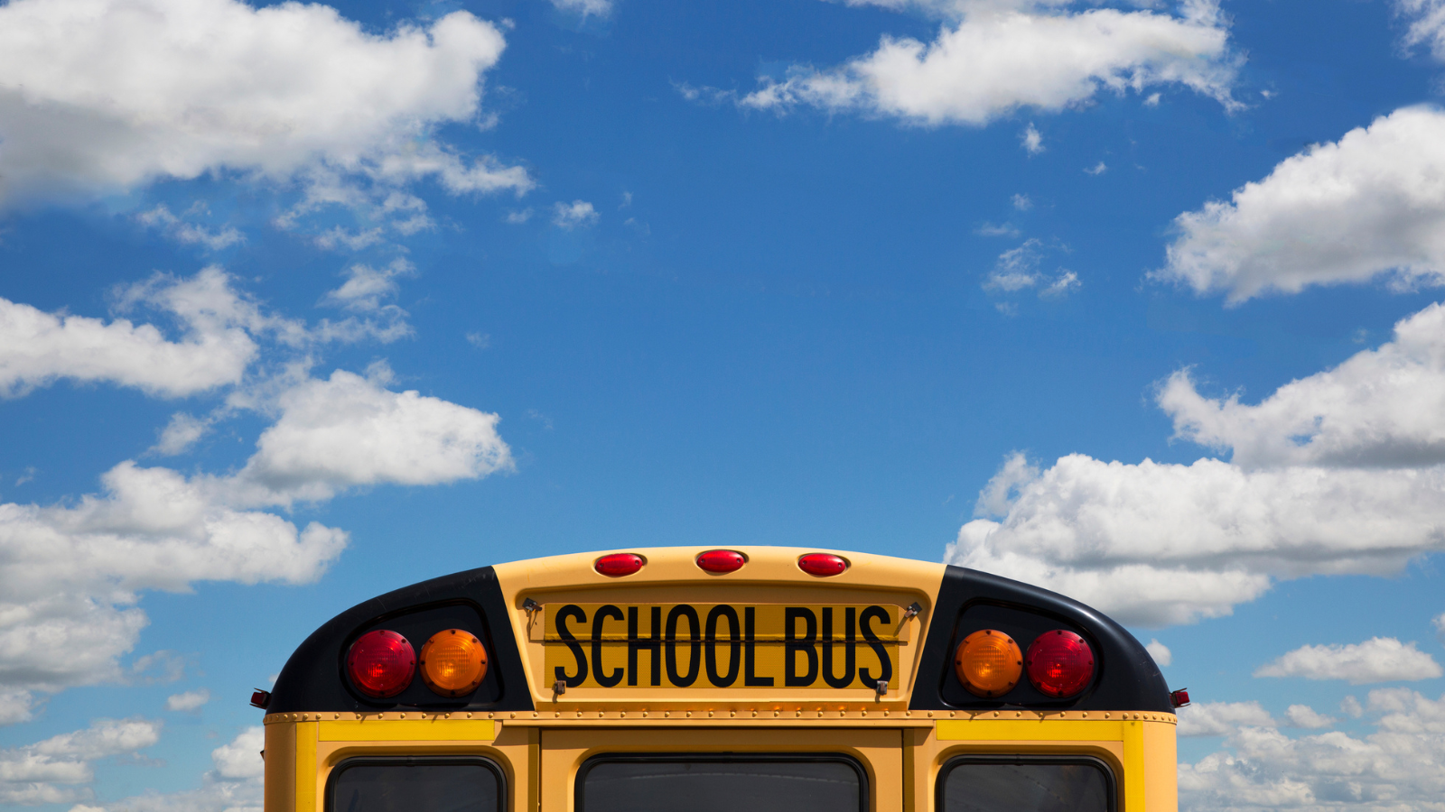 top of school bus with cloudy sky