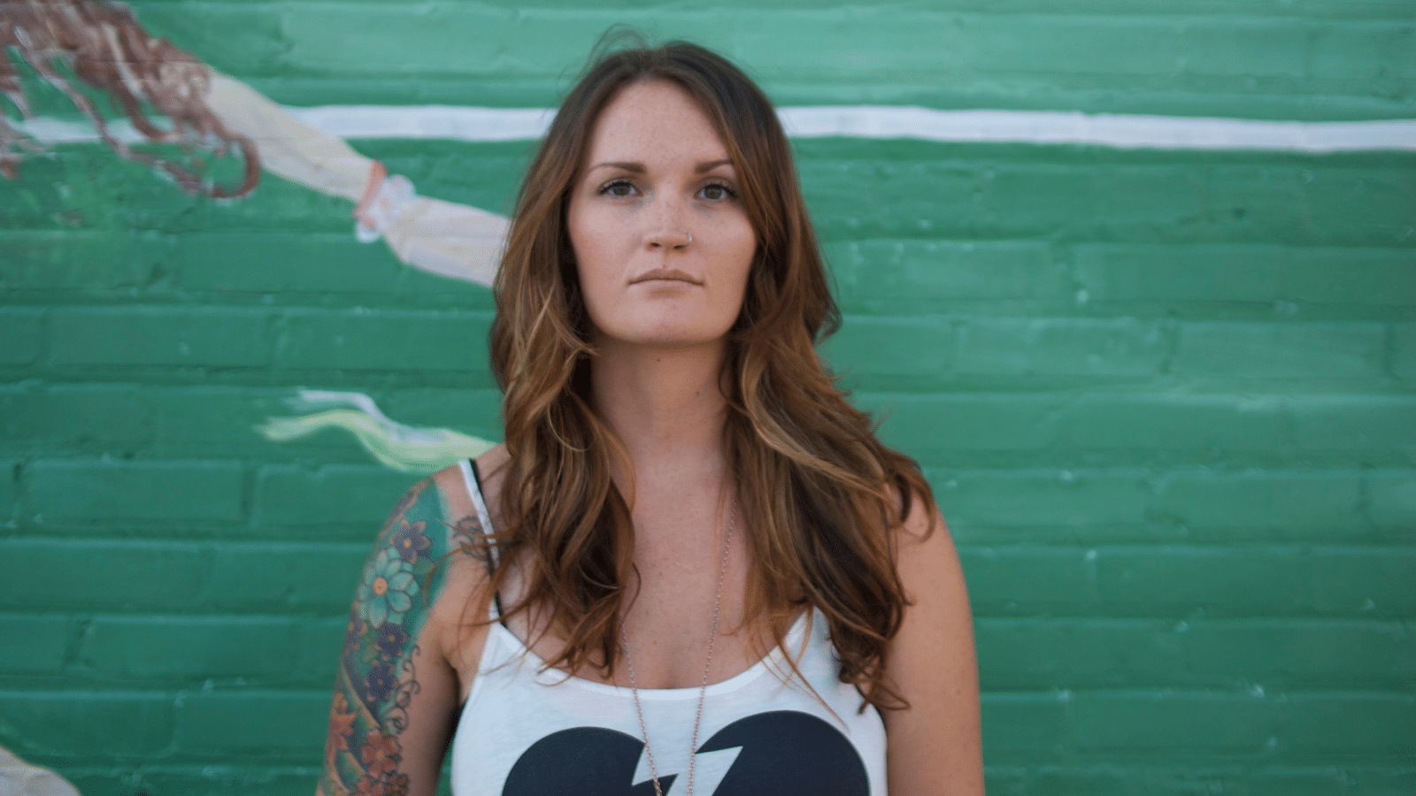 woman in tank top with tattoos