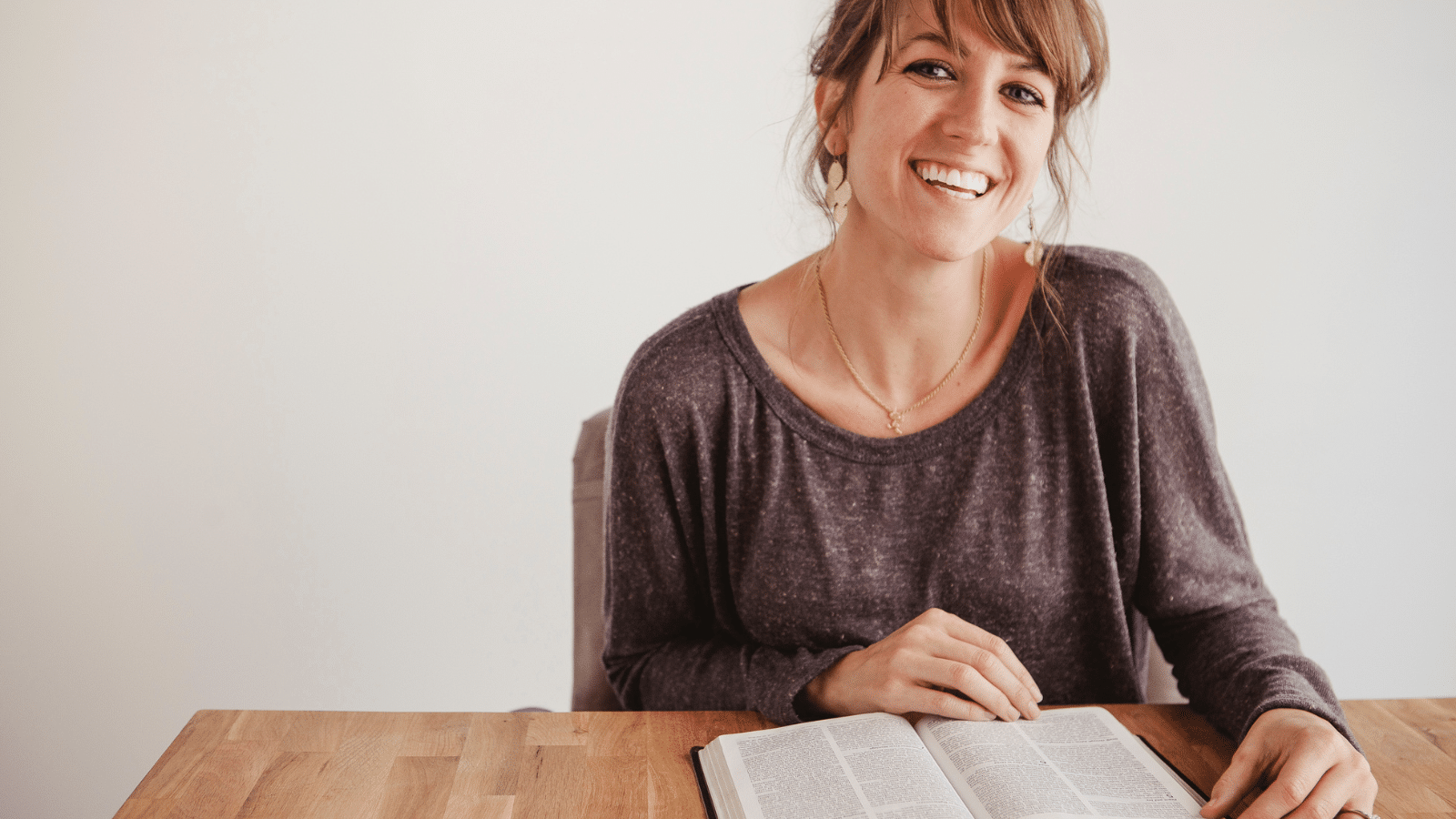 woman smiling with Bible