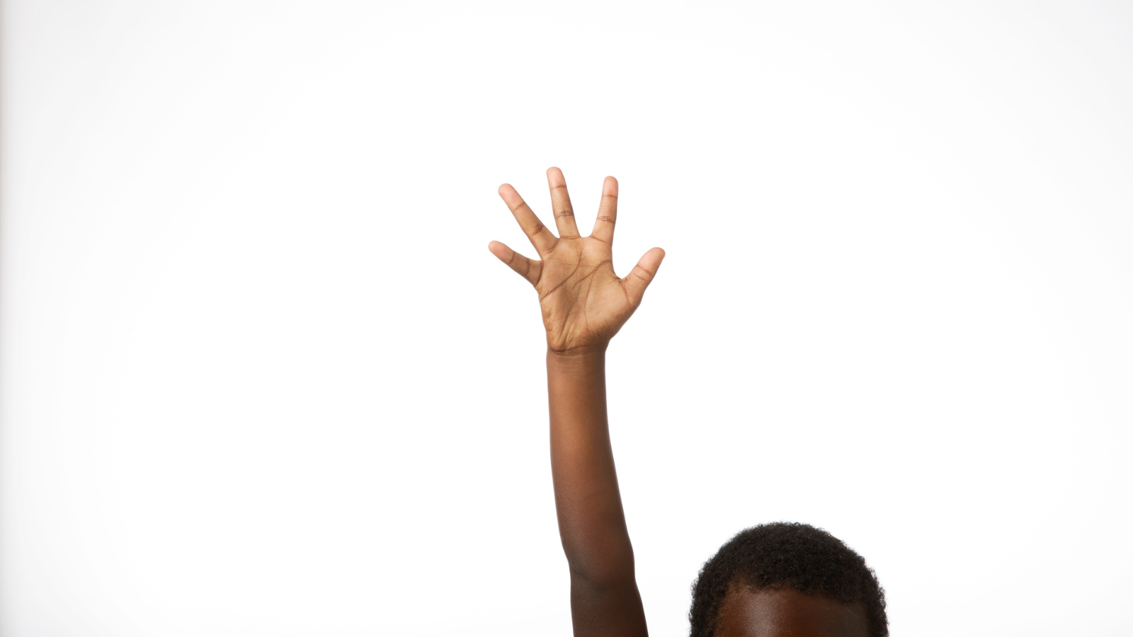 young boy raising hand