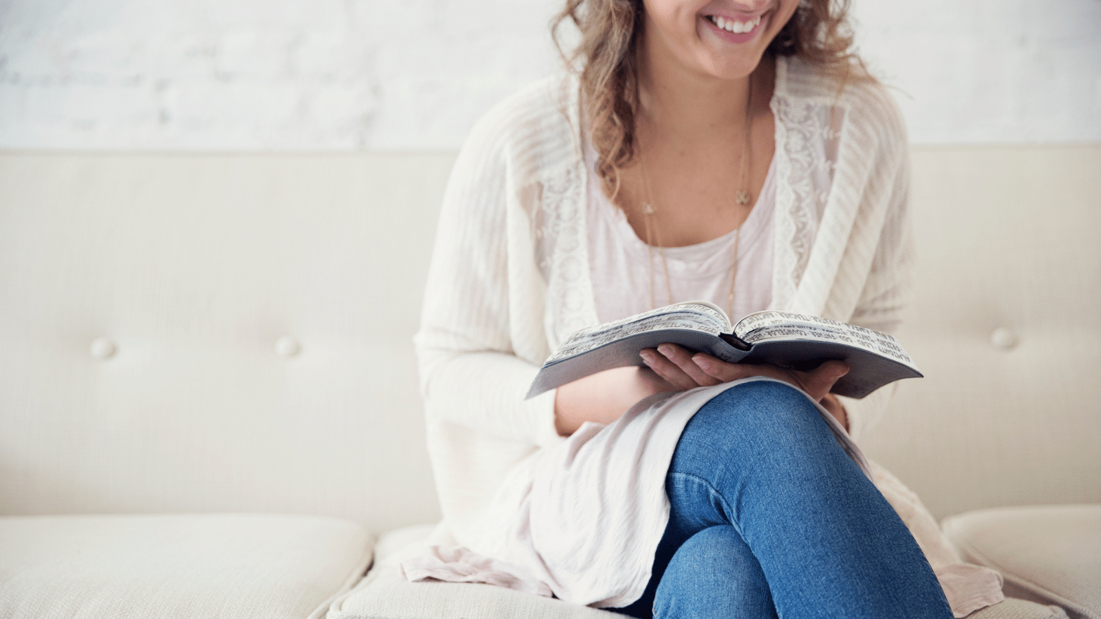 young girl reading the Bible and smiling