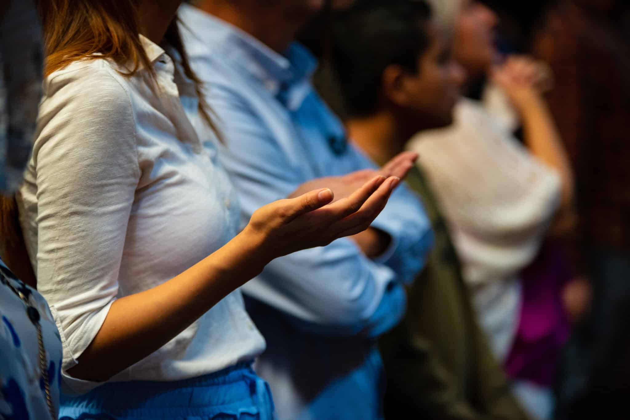 woman raising hands in worship