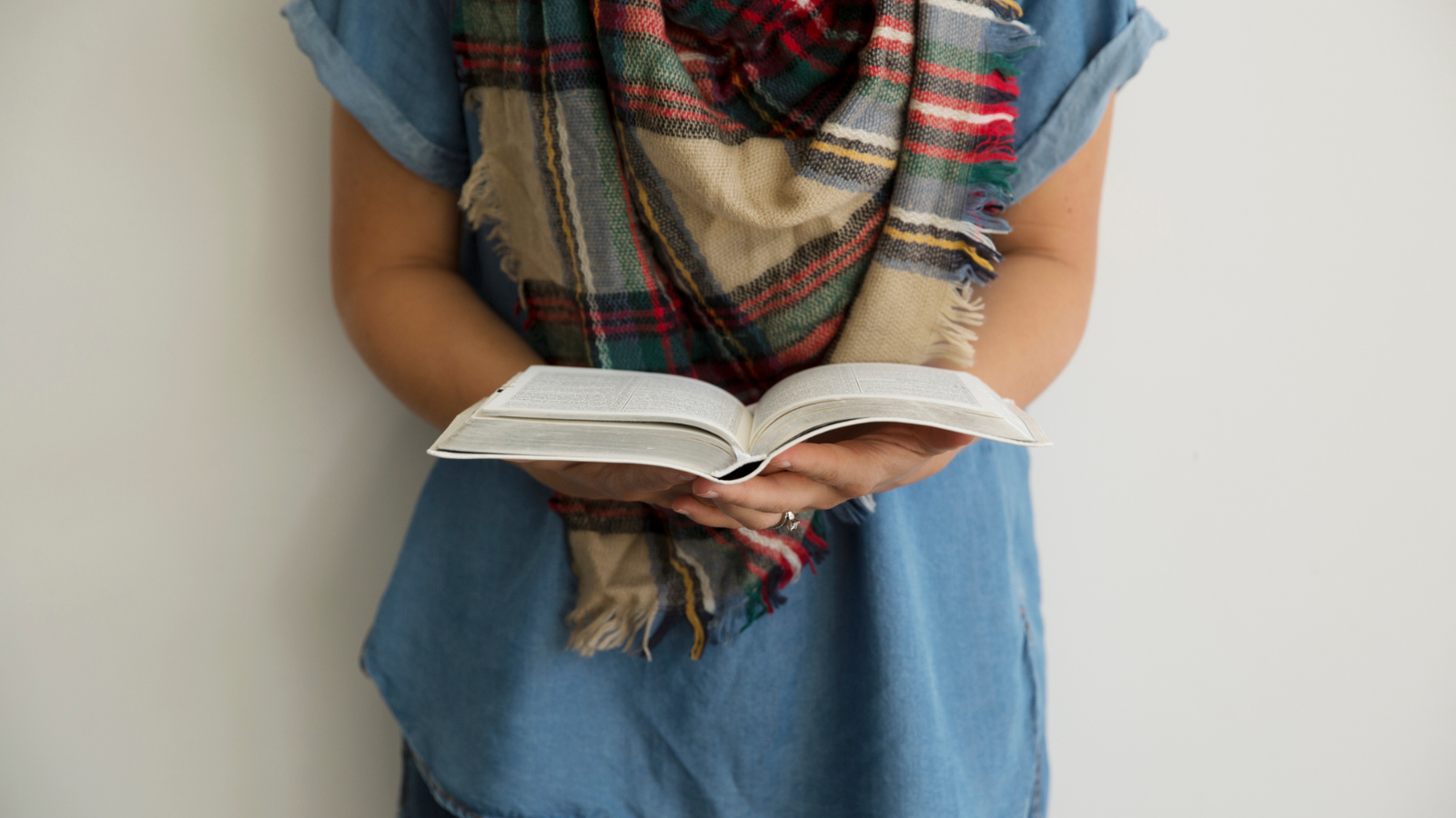 woman in scarf reading Bible