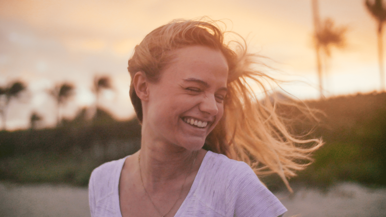 A woman standing outside smiling.