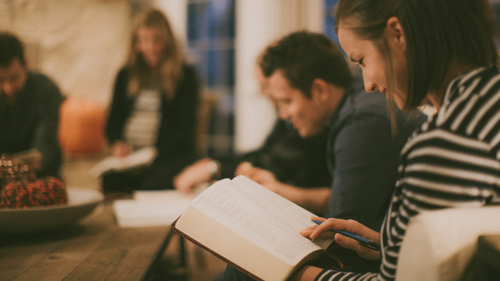 A group of people reading their bibles.