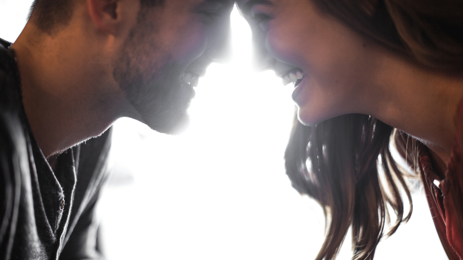 A man and woman smiling at each other.