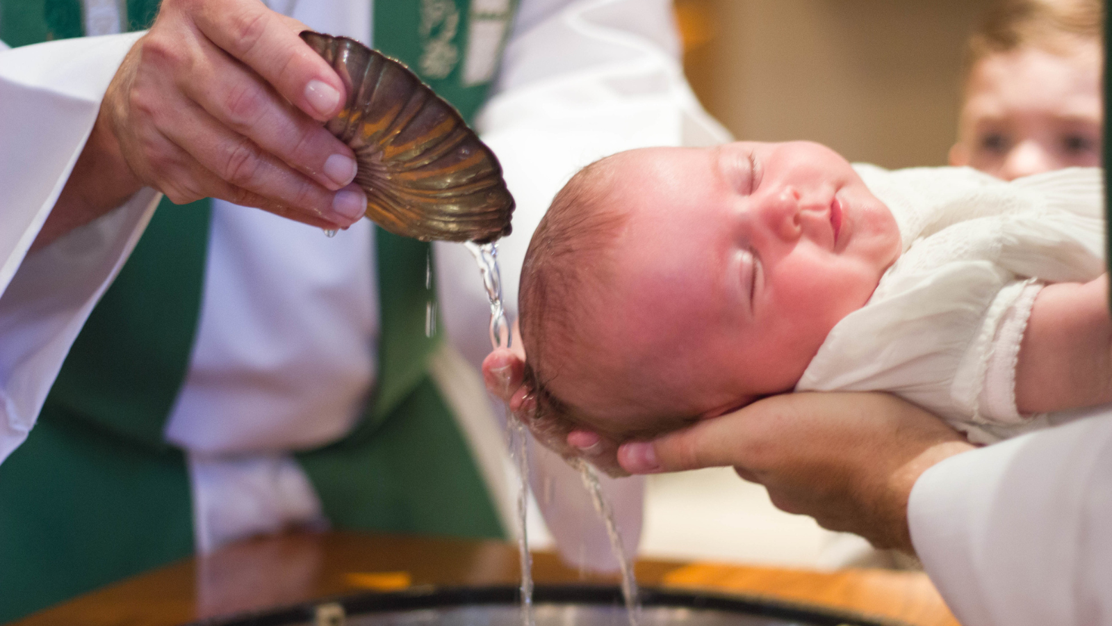 A baby being baptized.