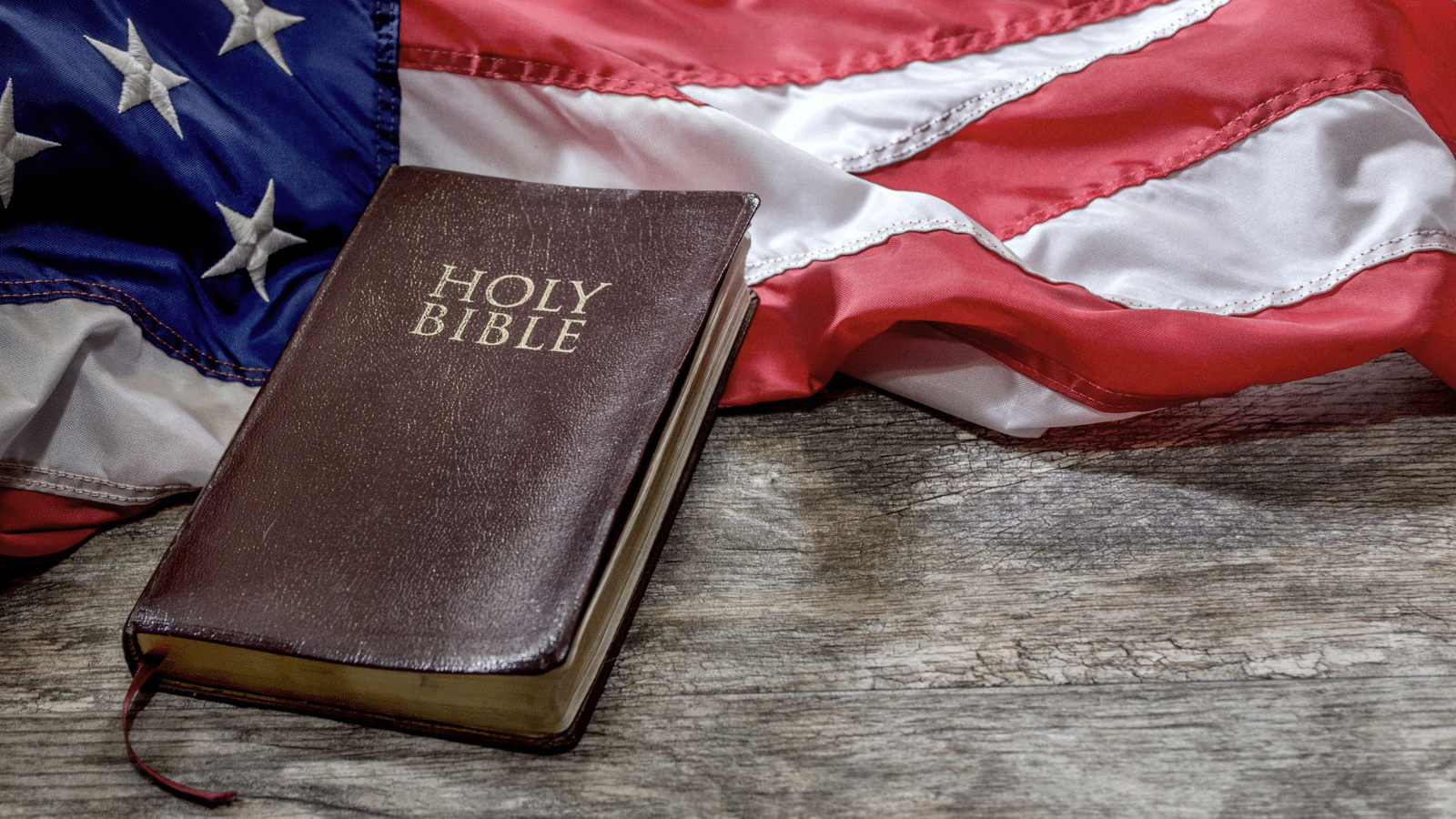 An America flag next to a bible.