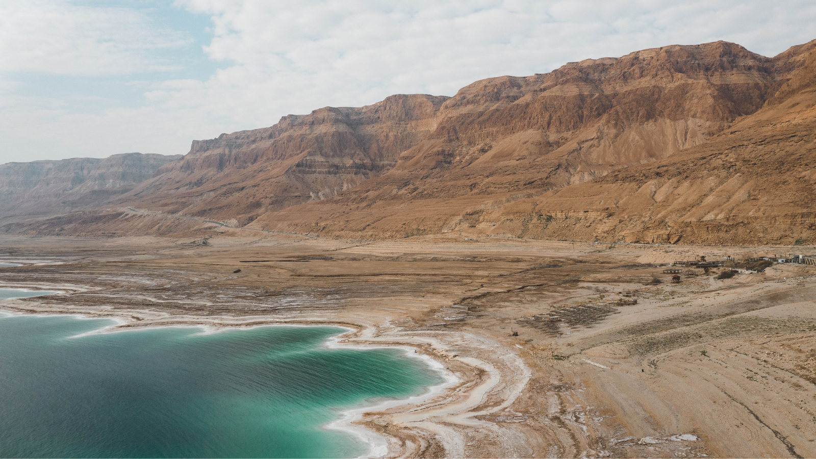 A view of the blue dead sea and surrounding mountains.