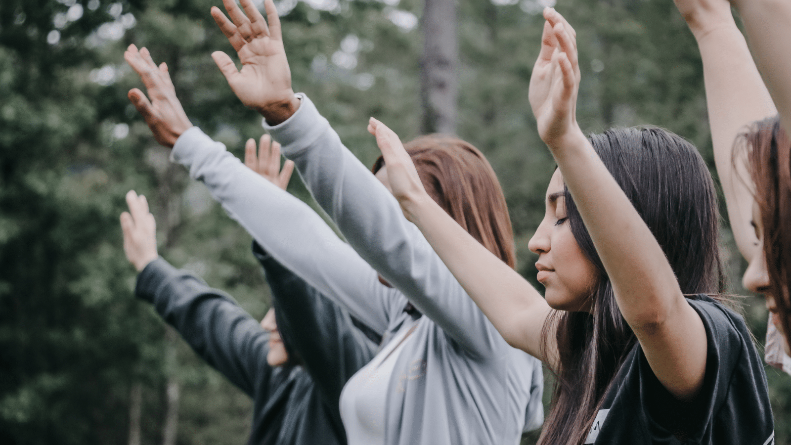 People holding up their hands in priase.