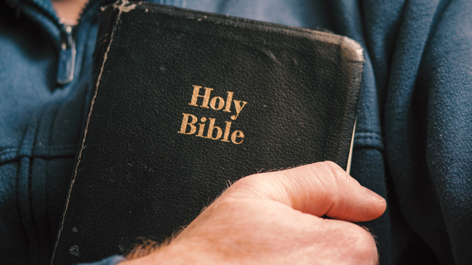A man holding the Holy Bible.