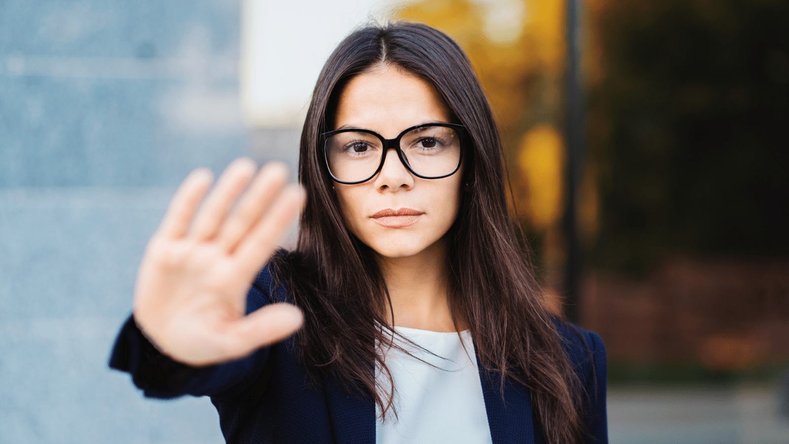 Portrait of young businesswoman disapproval gesture with hand