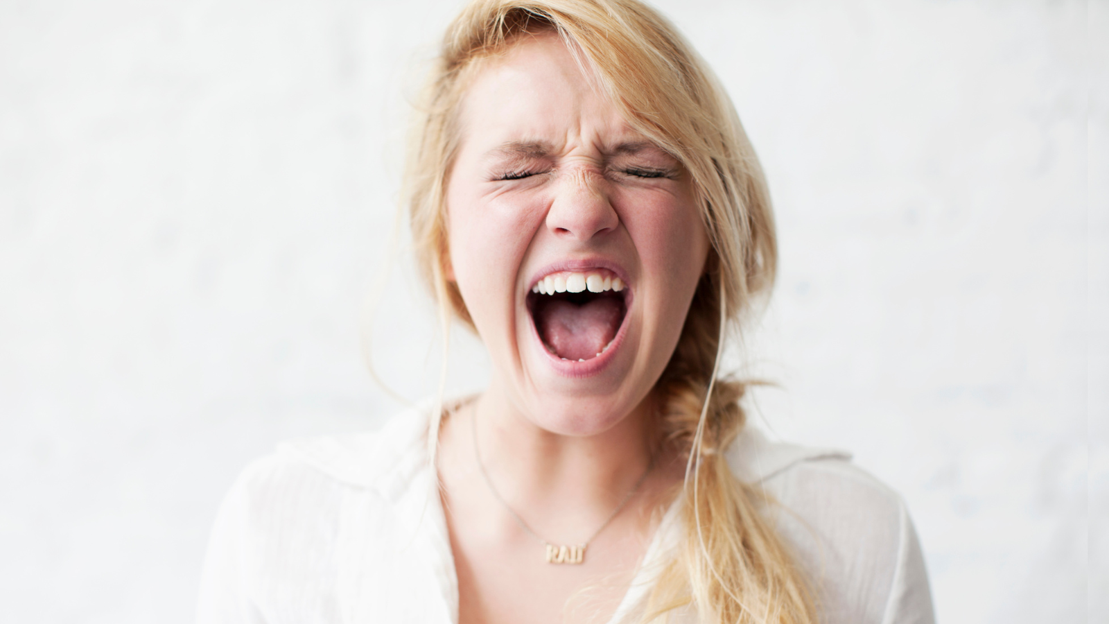 A blonde woman yelling.