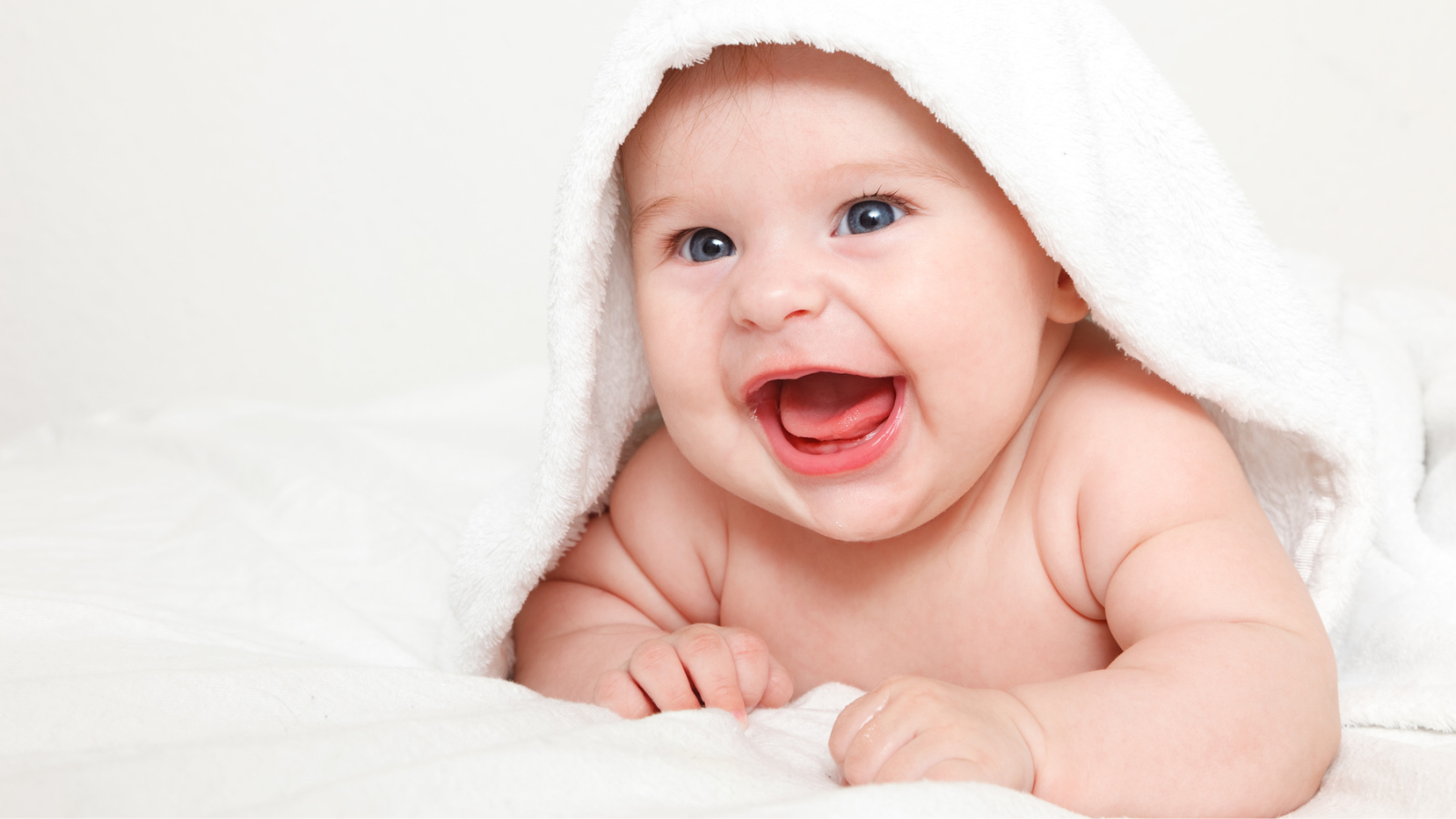 laughing baby with towel